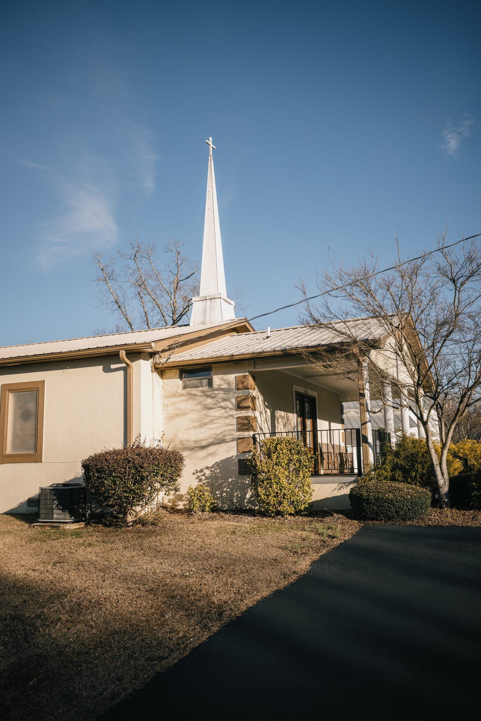 Soapstone Baptist Church's sanctuary building, with its white steeple and cross
