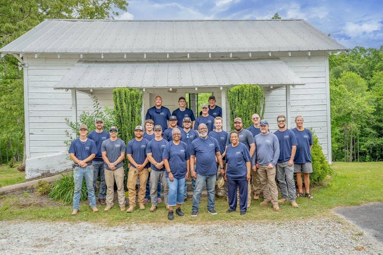 Harper General Contractors renovation crew in front of the one-room Soapstone school